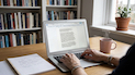 tiny image of chantalle rose sitting at a desk with a notebook typing onto a laptop