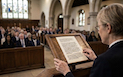 celebrant reading from text to a group in a chapel