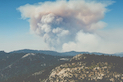 tiny image of a wildfire and smoke on distant hills